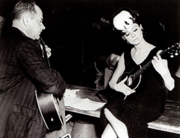 Audrey learning to play Moon River on the set of Breakfast at Tiffany's